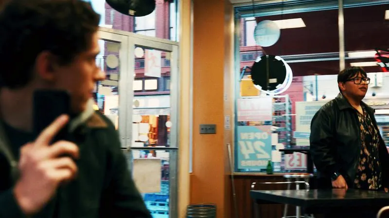 Ned Leeds in a cafe, not recognizing Peter Parker