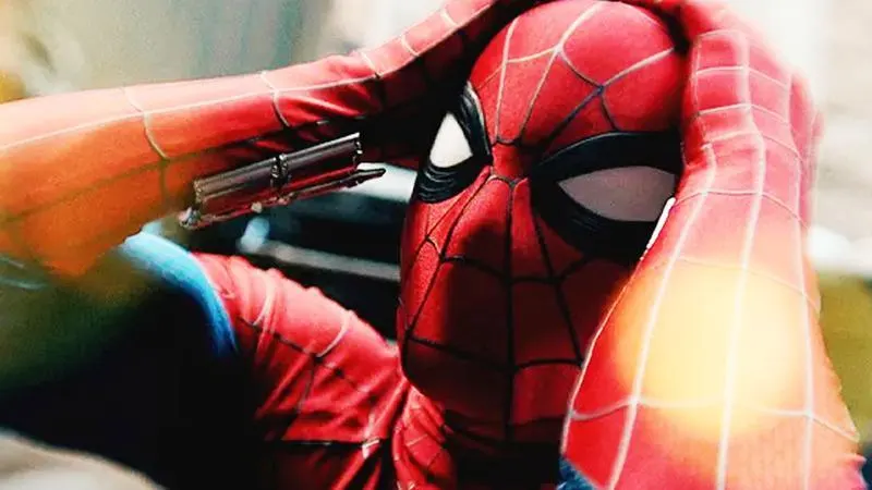 Spider-Man holding his head in distress