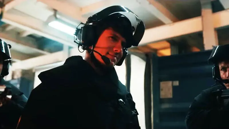 A DODC officer taken over by an unseen force, smirking