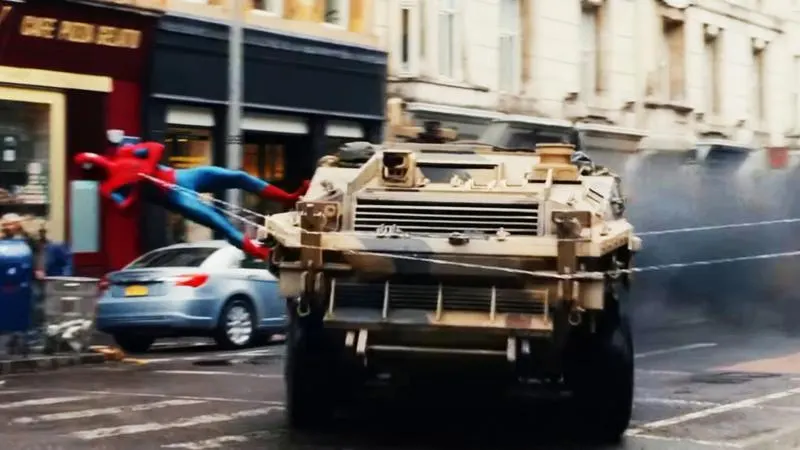 Spider-Man using his webs to stop an armored vehicle